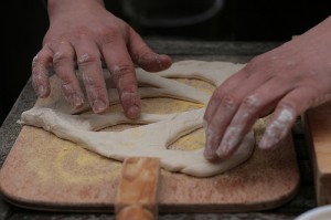 Shaping fougasse before it goes into the earth oven.
